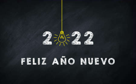 Feliz AÃ±o Nuevo 2022. Happy New Year in Spanish Idiom On chalkboard. Creative Concept. 2022 Light...
