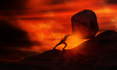 Man Pushing big stone uphill At Sunset. Businessman Push hardly the concrete Rock up to the top of mountain. Conceptual Image of Sisyphus and Hard Workの写真素材