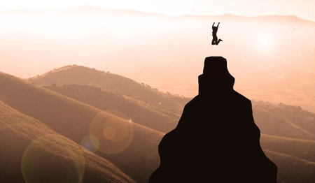silhouette of a young woman jumping on the top of the mountain celebrating Success. Business Women...