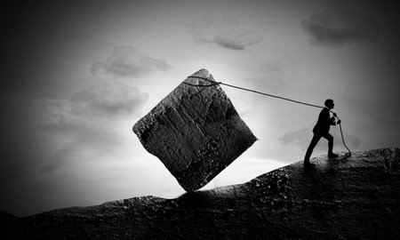 Surreal scene Of Young Businessman Pulling A Rock Block up to Hill. Sisyphus Concept. The Exhausted...