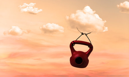 Cloud Carrying A Heavy Weight Flying with Difficulty. Concept of Held Back, Responsibility and Metaphor. Surreal Scene with Clouds and Kettlebell.の写真素材