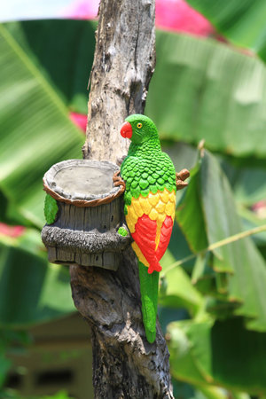 Colored Mold of Parrot sitting on tree, Sculpture parrot 