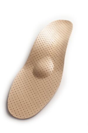 Isolated orthopedic insole on a white background. Treatment and prevention of flat feet and foot diseases. Foot care, comfort for the feet. Wear comfortable shoes. Medical insoles.の写真素材