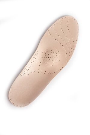 Medical insoles. Isolated orthopedic insoles on a white background. Treatment and prevention of flat feet and foot diseases. Foot care. Flat Feet Correction.の写真素材