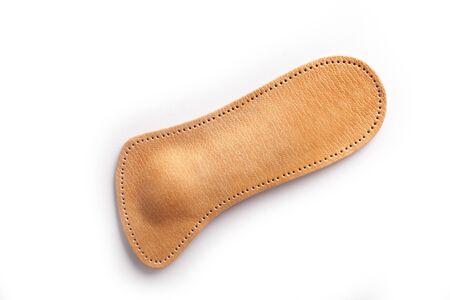 Isolated orthopedic insole on a white background. Treatment and prevention of flat feet and foot diseases. Foot care, comfort for the feet. Wear comfortable shoes. Medical insoles. Flat Feet Correction.の写真素材