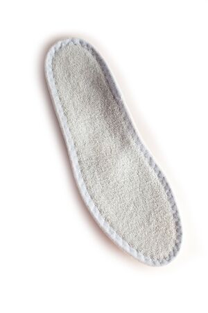 Isolated orthopedic insole on a white background. Treatment and prevention of flat feet and foot diseases. Foot care, comfort for the feet. Wear comfortable shoes. Medical insoles. Flat Feet Correction.の写真素材