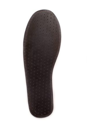 Isolated orthopedic insole on a white background. Treatment and prevention of flat feet and foot diseases. Foot care, comfort for the feet. Wear comfortable shoes. Medical insoles. Flat Feet Correction.の写真素材