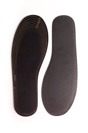 Isolated orthopedic insole on a white background. Treatment and prevention of flat feet and foot diseases. Foot care, comfort for the feet. Wear comfortable shoes. Medical insoles. Flat Feet Correction.の写真素材