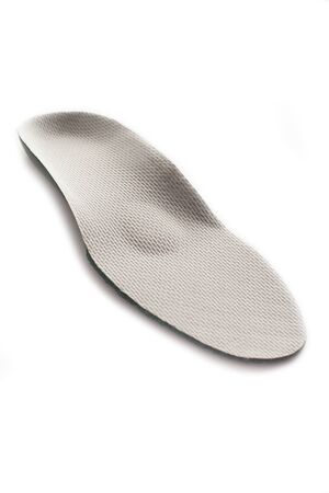 Isolated orthopedic insole on a white background. Treatment and prevention of flat feet and foot...