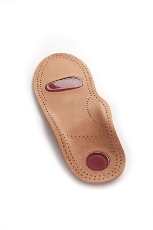 Medical insoles. Isolated orthopedic insoles on a white background. Treatment and prevention of flat feet and foot diseases. Foot care. Flat Feet Correction.の写真素材
