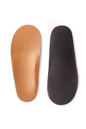 Medical insoles. Isolated orthopedic insoles on a white background. Treatment and prevention of flat feet and foot diseases. Foot care. Flat Feet Correction.の写真素材