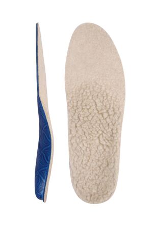 Isolated orthopedic insole on a white background. Treatment and prevention of flat feet and foot diseases. Foot care, comfort for the feet. Wear comfortable shoes. Medical insoles. Flat Feet Correction.の写真素材