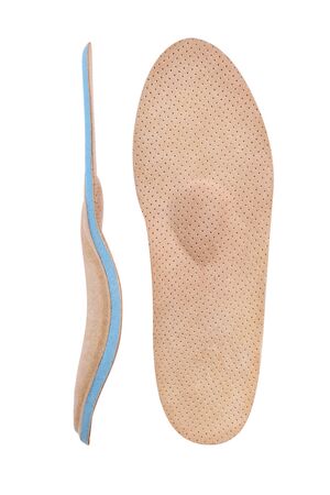 Isolated orthopedic insole on a white background. Treatment and prevention of flat feet and foot diseases. Foot care, comfort for the feet. Wear comfortable shoes. Medical insoles. Flat Feet Correction.の写真素材