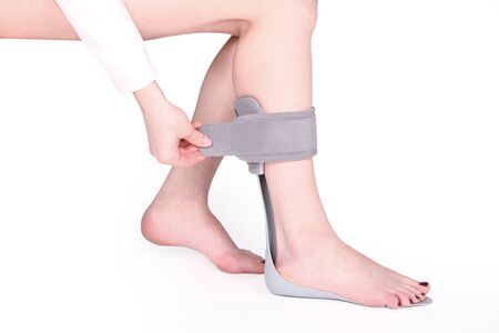 Orthopedic Ankle Brace. Medical Ankle Bandage. Medical Ankle Support Strap Adjustable Wrap Bandage Brace foot Pain Relief Sport. Leg Brace isolated on white backgroundの写真素材
