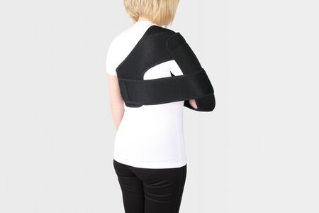 Shoulder Joint Brace. Bandage on the shoulder joint (scarf) with additional fixation. Deso's Handwrap. Supports & Immobilizers. Orthopedic medical braces. Shoulder injury.の写真素材
