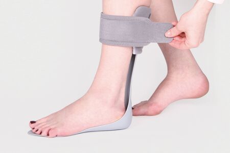 Orthopedic Ankle Brace. Medical Ankle Bandage. Medical Ankle Support Strap Adjustable Wrap Bandage Brace foot Pain Relief Sport. Leg Brace isolated on white backgroundの写真素材