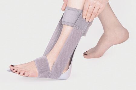 Orthopedic Ankle Brace. Medical Ankle Bandage. Medical Ankle Support Strap Adjustable Wrap Bandage Brace foot Pain Relief Sport. Leg Brace isolated on white backgroundの写真素材
