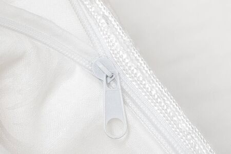 Folded soft white blanket, bedspread or duvet for a comfortable sleep. White blanket folded on a white background. Fabric structure. 3D blanket model. Comfortable sleep. Close up photoの写真素材