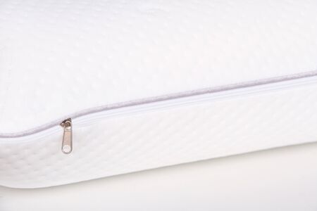 Orthopedic Pillow with a Memory Effect. Medical treatment pillow for sleep. Comfort Memory Pillow under the head with a recess under the shoulder isolated on white background. Sleeping support pillowの写真素材