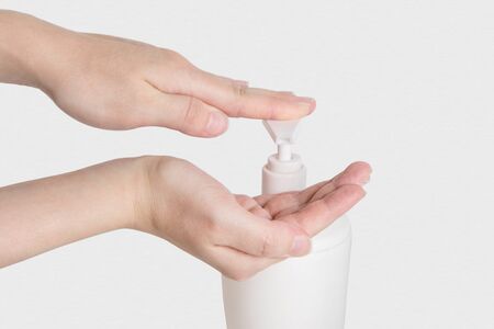 Hand antibacterial sanitizer dispenser pump, alcohol gel to wash hands, liquid soap to clean hands free from viruses and diseases. Please wash your hands concept photo of handwashing isolated on whiteの写真素材