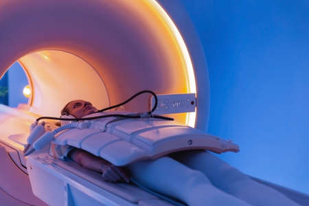 Medical CT or MRI Scan with a patient in the modern hospital laboratory. Interior of radiography department. Technologically advanced equipment in white room. Magnetic resonance diagnostics machine.の写真素材