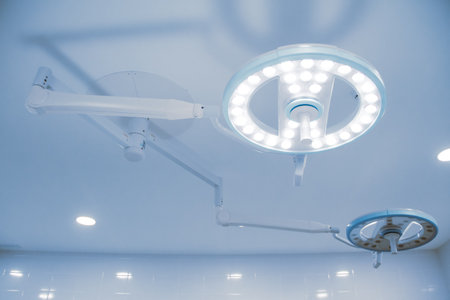 Empty operating room in a hospital. Surgical equipment with operating table. Medical device for emergency patient in blue tone style. Blank Emergency Surgery Room. Clinic interior for background.の写真素材