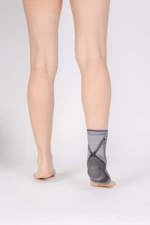 Orthopedic Ankle Brace. Medical Ankle Bandage. Medical Ankle Support Strap Adjustable Wrap Bandage Brace foot Pain Relief Sport. Leg Brace isolated on white background. Trauma Ankle orthosis. Injury.の写真素材