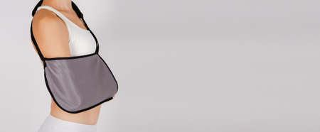 Shoulder Joint Brace. Bandage on the shoulder joint scarf with additional fixation. Deso Handwrap. Supports and Immobilizers. Orthopedic medical Braces. Shoulder injury.の写真素材