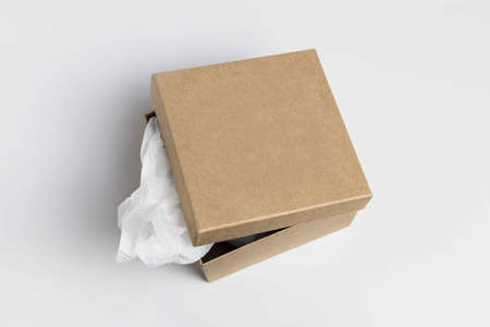 Cardboard craft box. Mailbox isolated on a white background. Open rectangular small brown box for transporting goods isolated on a white background, front view. Recycled paper.の写真素材