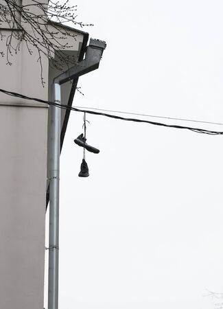 Russia, Moscow, the sad mood of the city during the crisis - sneakers on wires and spring cloudy weather.の写真素材