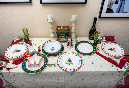 Dolgoprudny, Russia. 11/12/2021. Festive table setting in the kitchen. Christmas kitchen interior and New Year's dishes on the table.のeditorial素材