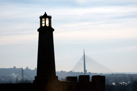 Belgrade. Serbia. 12.23.2020. The outlines of the lighthouse and bridge in the city center against the blue sky. Recognizable symbols of the city in the spring haze.のeditorial素材