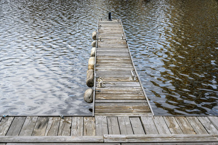Russia, Moscow region. Empty Marina. Platforms from wooden boards with buoys and waves in the port....