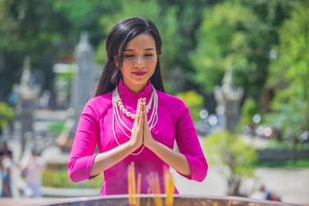 VIETNAM, NHA TRANG, FEBRUARY 2016 - woman praying in templeのeditorial素材