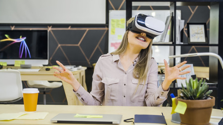Young creative girl uses vr glasses in office