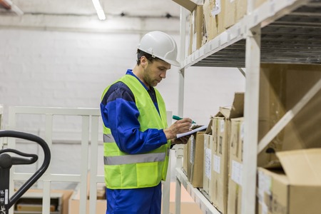 Warehouse worker looking at documents