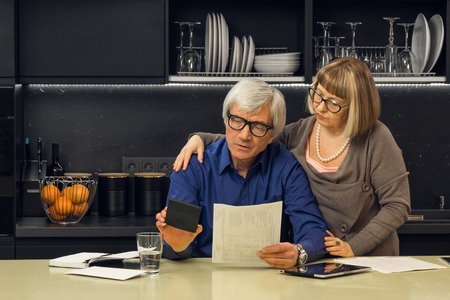 Senior couple calculate their billsの写真素材