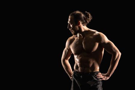 An athletic man on dark background