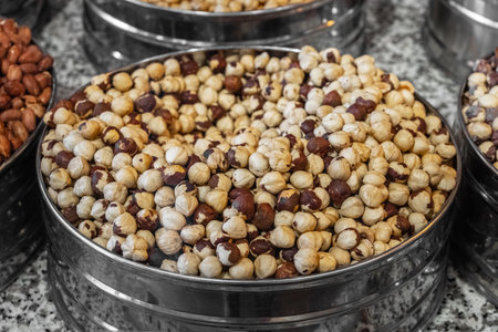 Roasted hazelnuts in metal containerの写真素材