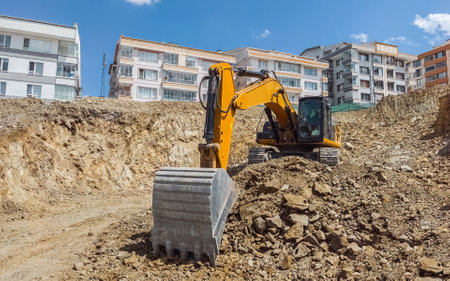 Excavator at urban construction site