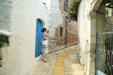 A girls walks through the beautiful narrow streets in Crete, Greece. High quality photoの写真素材