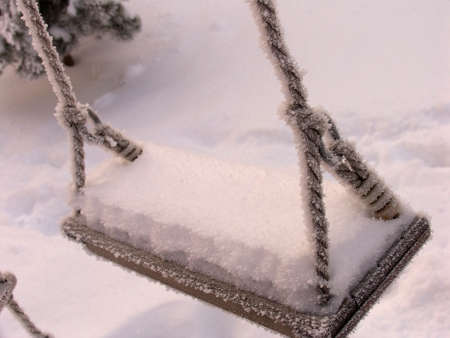 Swing in the snow. Playground in winter. High quality photoの写真素材