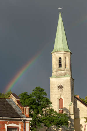 After a thunderstorm, the sunlight, the rainbow and the dark gray sky, the city. high quality photoの写真素材