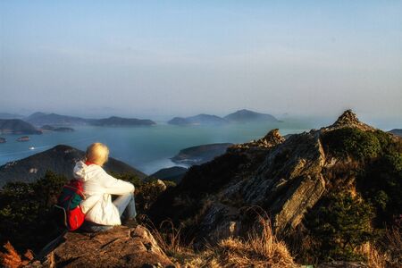 Mountains with heavy backpack Travel Lifestyle wanderlust adventure concept vacationsの写真素材
