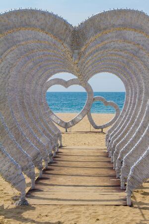 beautiful installation of hearts on the beach of the oceanの写真素材