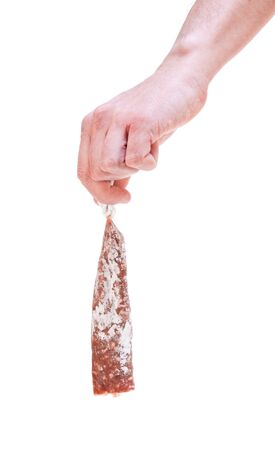 Hand holding a dry salami on whiteの写真素材
