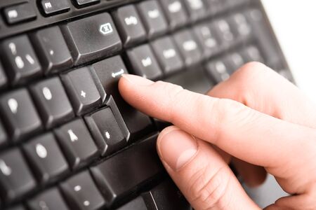 Hands typing on laptop keyboard