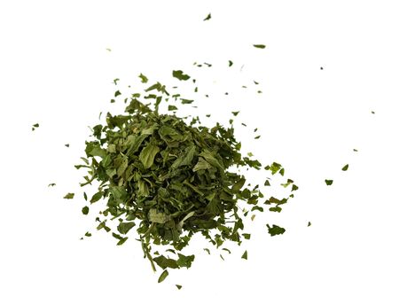 Pinch of dried parsley isolated on white backgroundの写真素材