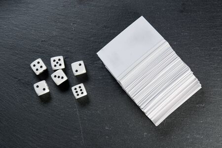 Black stone blackboard with playing dice on