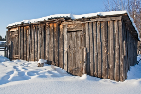 Old wooden barn in snowの写真素材